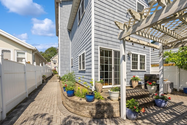 79 Orland St, Milford, CT 06460 - view of side of property featuring a patio area, a pergola, and a fenced backyard
