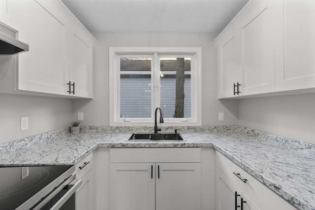 226 E Main St Apt 4, Bristol, CT 06010 - kitchen featuring white cabinetry, a textured ceiling, and stainless steel electric stove