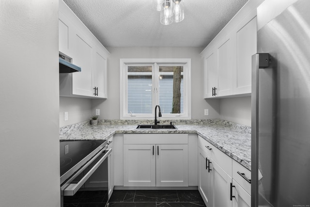 226 E Main St Apt 4, Bristol, CT 06010 - kitchen with stainless steel appliances, wall chimney range hood, dark marble finish floors, white cabinetry, and a textured ceiling