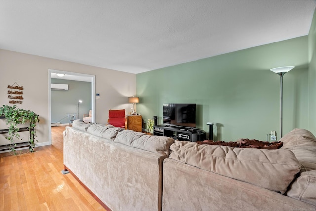 61 Mansfield Rd, New London, CT 06320 - living room featuring a wall unit AC, a baseboard radiator, and wood finished floors