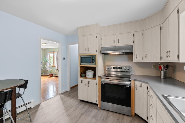 61 Mansfield Rd, New London, CT 06320 - kitchen with appliances with stainless steel finishes, under cabinet range hood, light wood-style flooring, a baseboard heating unit, and light countertops