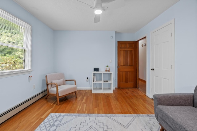 61 Mansfield Rd, New London, CT 06320 - sitting room featuring baseboard heating, light wood-style floors, and ceiling fan