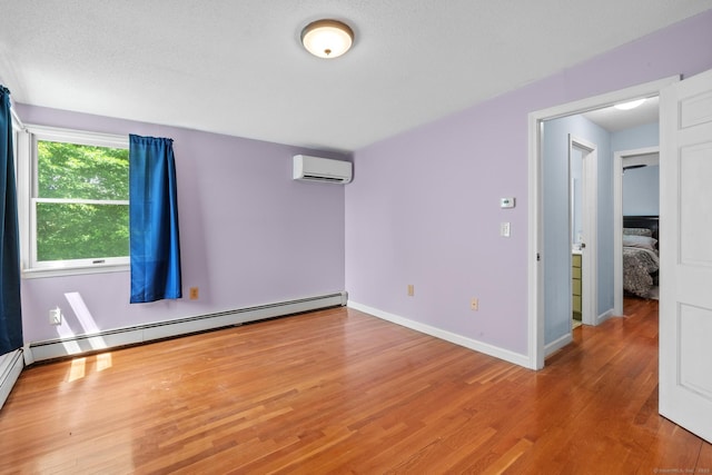 61 Mansfield Rd, New London, CT 06320 - spare room with a wall unit AC, wood finished floors, and a baseboard radiator