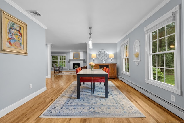 477 Skyline Dr, Orange, CT 06477 - dining area with a baseboard heating unit, a brick fireplace, healthy amount of natural light, light wood-type flooring, and ornamental molding