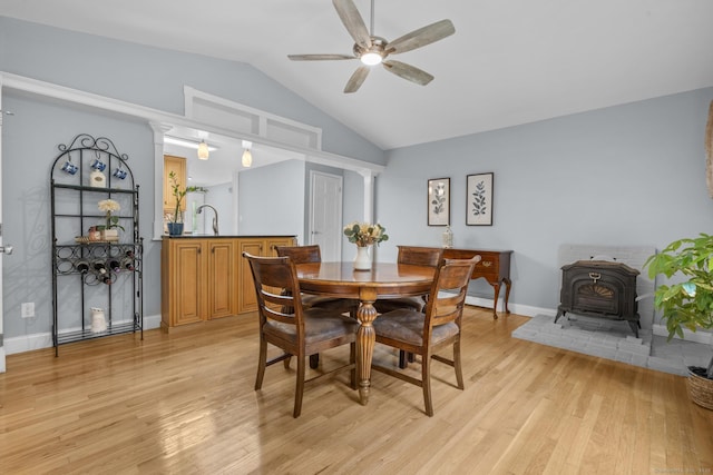 477 Skyline Dr, Orange, CT 06477 - dining space featuring a wood stove, ceiling fan, vaulted ceiling, and light wood-style floors