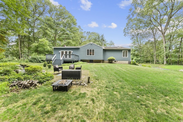 477 Skyline Dr, Orange, CT 06477 - back of property featuring an outdoor fire pit, a wooden deck, and a lawn