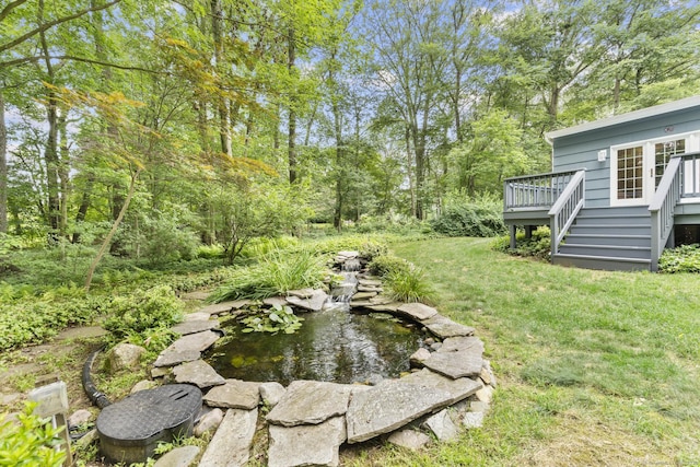 477 Skyline Dr, Orange, CT 06477 - view of grassy yard with a deck, a small pond, and stairway