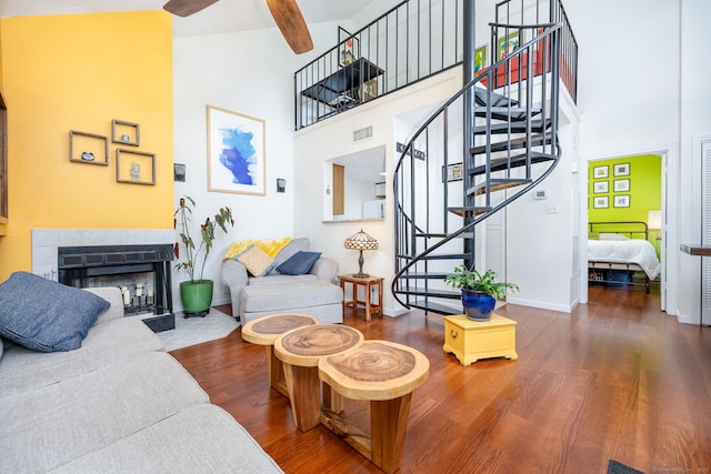 278 Carriage Crossing Ln Unit 278, Middletown, CT 06457 - living area featuring a towering ceiling, wood finished floors, stairs, ceiling fan, and a fireplace