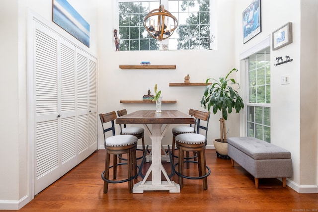 278 Carriage Crossing Ln Unit 278, Middletown, CT 06457 - dining space featuring a chandelier, wood finished floors, and a towering ceiling