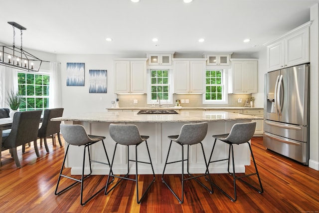 31 Galbraith Rd, Stafford, CT 06071 - kitchen with stainless steel fridge with ice dispenser, glass insert cabinets, white cabinets, decorative backsplash, and light stone counters
