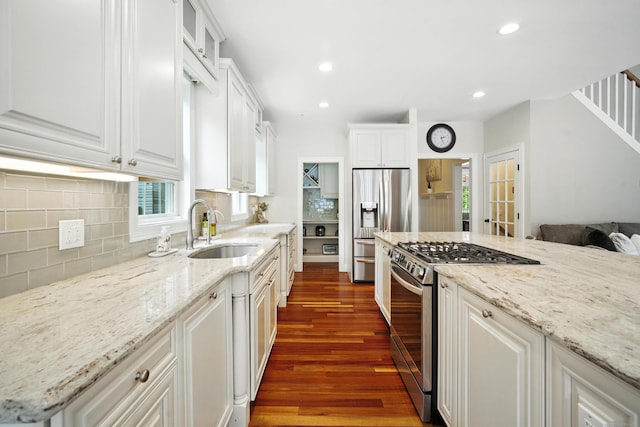 31 Galbraith Rd, Stafford, CT 06071 - kitchen featuring appliances with stainless steel finishes, dark wood-style flooring, white cabinetry, tasteful backsplash, and light stone counters