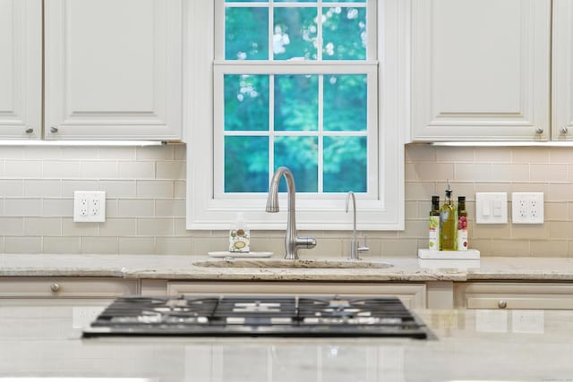 31 Galbraith Rd, Stafford, CT 06071 - kitchen featuring stainless steel gas stovetop, white cabinetry, and decorative backsplash
