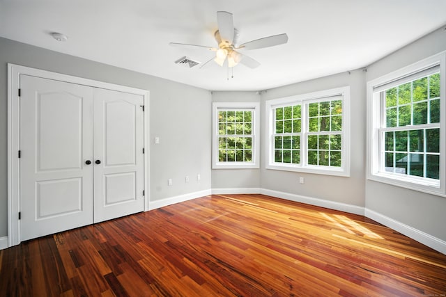 31 Galbraith Rd, Stafford, CT 06071 - unfurnished bedroom featuring multiple windows, wood finished floors, a closet, and ceiling fan