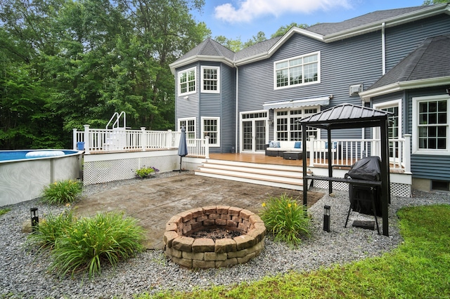 31 Galbraith Rd, Stafford, CT 06071 - rear view of property featuring an outdoor pool, a gazebo, a fire pit, a deck, and a patio area