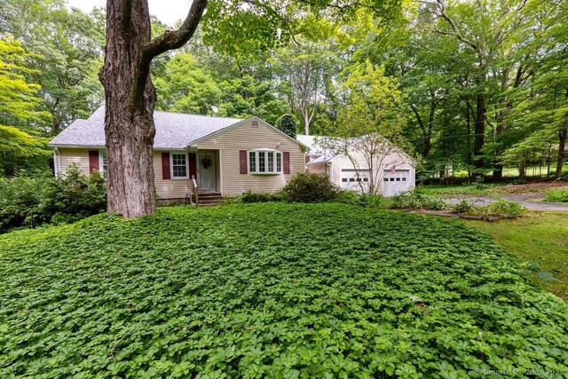 169 Wheeling Rd, Andover, CT 06232 - ranch-style house with a garage, a shingled roof, and an outdoor structure
