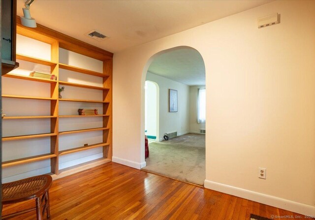 169 Wheeling Rd, Andover, CT 06232 - spare room with arched walkways and wood finished floors