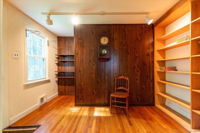 169 Wheeling Rd, Andover, CT 06232 - sitting room with rail lighting, wood finished floors, and wood walls