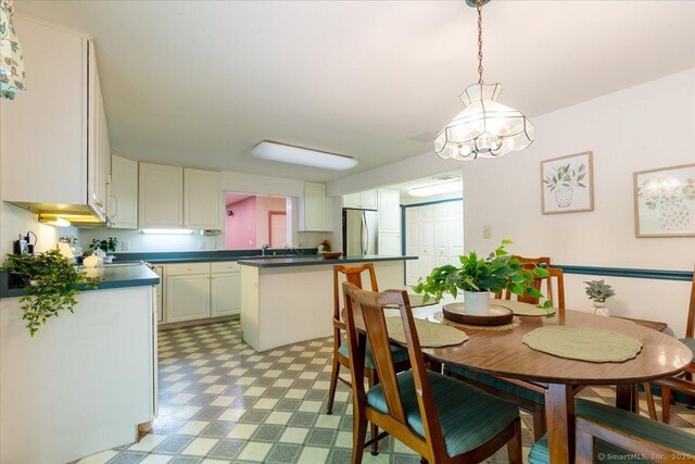 169 Wheeling Rd, Andover, CT 06232 - dining room with light floors and a chandelier