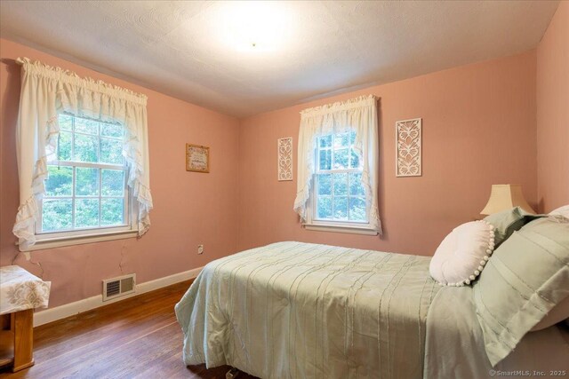 169 Wheeling Rd, Andover, CT 06232 - bedroom featuring multiple windows and wood finished floors