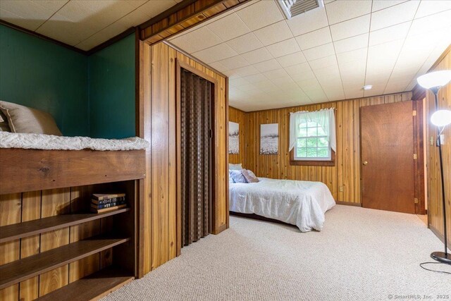 169 Wheeling Rd, Andover, CT 06232 - bedroom with carpet flooring and wood walls