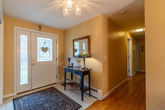 4 Melburn Ave, East Hampton, CT 06424 - entryway with a chandelier, a baseboard heating unit, and light tile patterned floors
