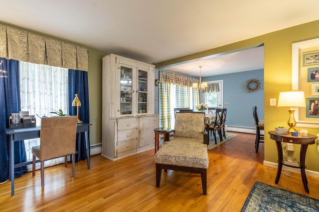 4 Melburn Ave, East Hampton, CT 06424 - living area with a chandelier, light wood-type flooring, and a baseboard radiator
