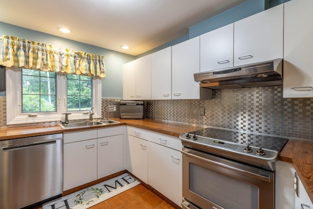 4 Melburn Ave, East Hampton, CT 06424 - kitchen featuring stainless steel appliances, under cabinet range hood, butcher block counters, decorative backsplash, and recessed lighting