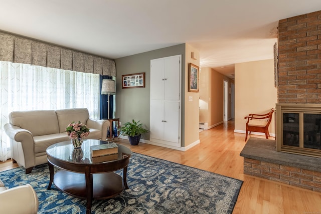 4 Melburn Ave, East Hampton, CT 06424 - living area featuring wood finished floors, a baseboard heating unit, and a fireplace
