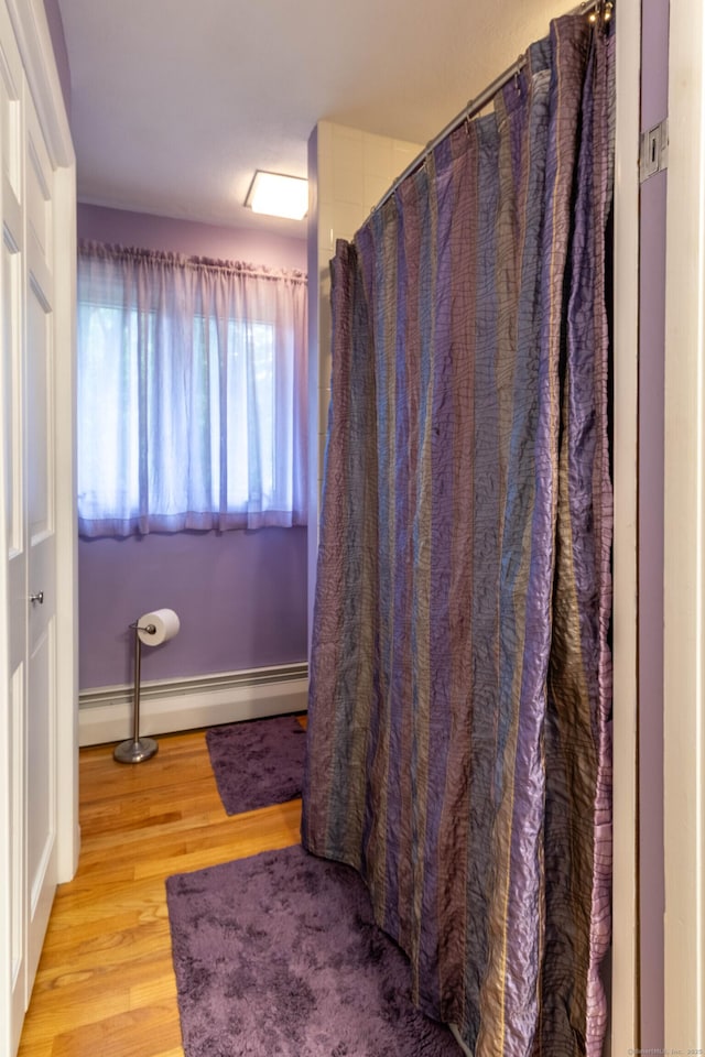 4 Melburn Ave, East Hampton, CT 06424 - bathroom featuring baseboard heating, wood finished floors, and a shower with shower curtain