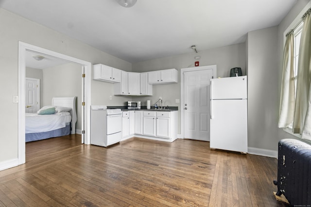 1492 Dixwell Ave, Hamden, CT 06514 - kitchen featuring white appliances, dark countertops, dark wood finished floors, and white cabinets