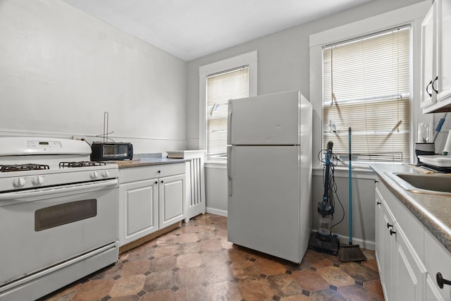 1492 Dixwell Ave, Hamden, CT 06514 - kitchen with white appliances, plenty of natural light, white cabinets, and light countertops
