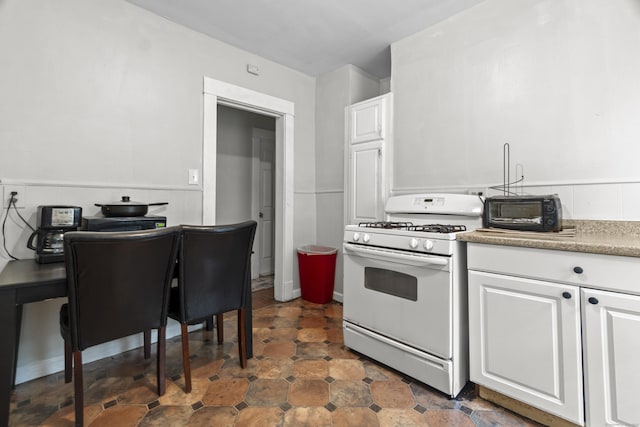 1492 Dixwell Ave, Hamden, CT 06514 - kitchen with gas range gas stove and white cabinetry