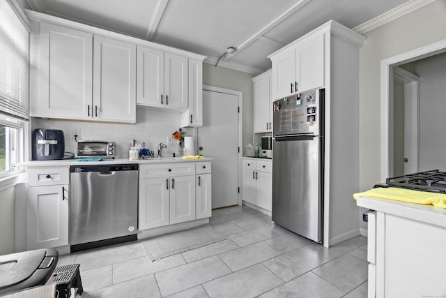 1492 Dixwell Ave, Hamden, CT 06514 - kitchen featuring appliances with stainless steel finishes, tasteful backsplash, ornamental molding, white cabinetry, and light countertops