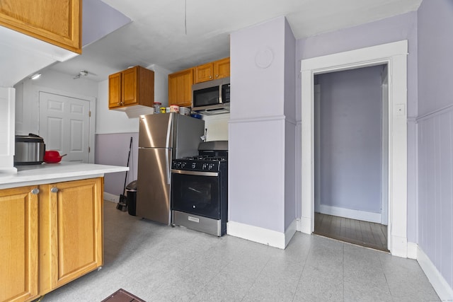 1492 Dixwell Ave, Hamden, CT 06514 - kitchen featuring stainless steel appliances, light countertops, and brown cabinets