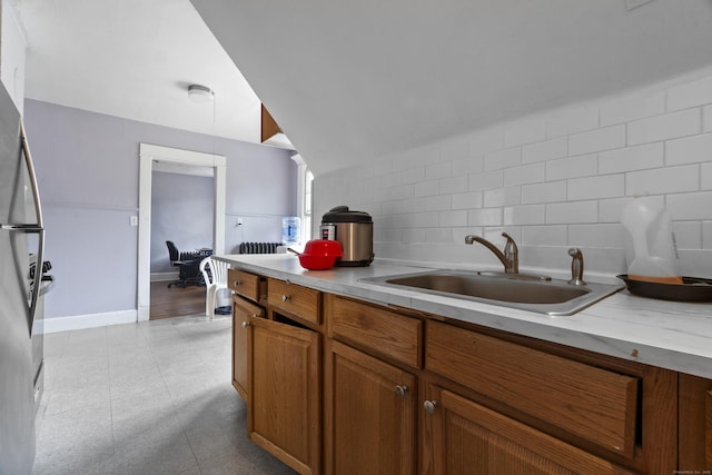 1492 Dixwell Ave, Hamden, CT 06514 - kitchen featuring backsplash, brown cabinets, and light countertops