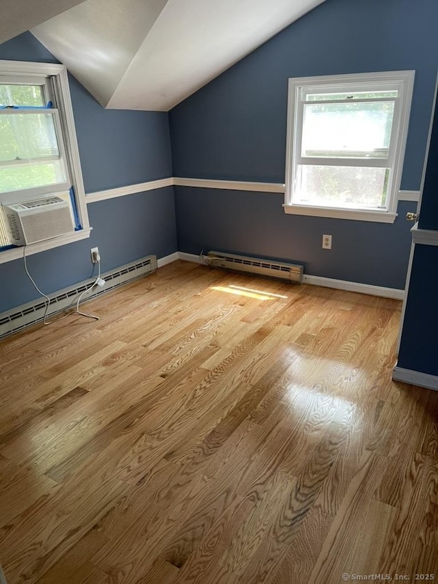 236 Mistuxet Ave, Stonington, CT 06355 - additional living space featuring vaulted ceiling, a baseboard heating unit, wood finished floors, plenty of natural light, and a baseboard radiator