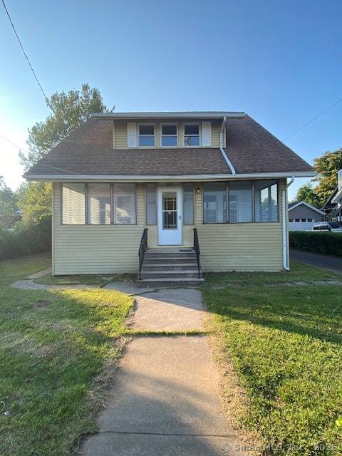 524 Broad St, Bristol, CT 06010 - bungalow-style house with entry steps, a front lawn, and a shingled roof