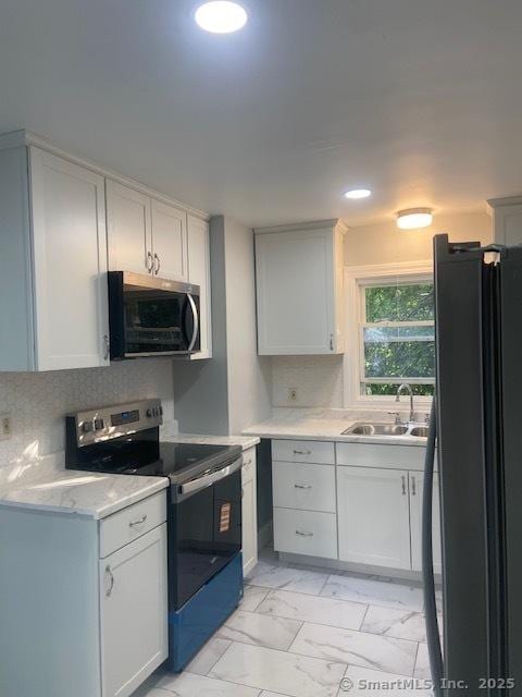 524 Broad St, Bristol, CT 06010 - kitchen with stainless steel appliances, light marble finish floors, decorative backsplash, and recessed lighting