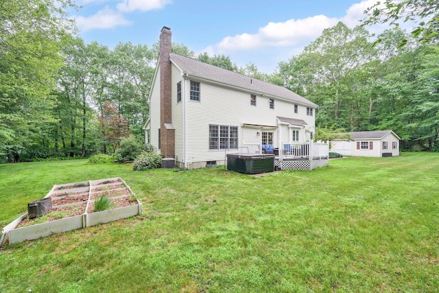 190 Charles St, Tolland, CT 06084 - back of property with a garden, a chimney, a wooden deck, and a yard