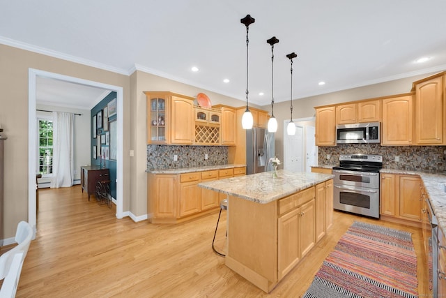 190 Charles St, Tolland, CT 06084 - kitchen with appliances with stainless steel finishes, light wood finished floors, backsplash, a kitchen island, and glass insert cabinets