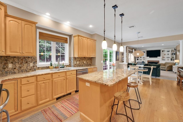 190 Charles St, Tolland, CT 06084 - kitchen with stainless steel dishwasher, light brown cabinetry, a center island, crown molding, and a breakfast bar area