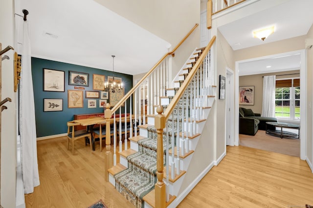 190 Charles St, Tolland, CT 06084 - stairway featuring wood finished floors and a chandelier