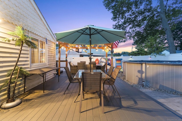 107 May St, West Haven, CT 06516 - deck at dusk with outdoor dining space and a fenced backyard