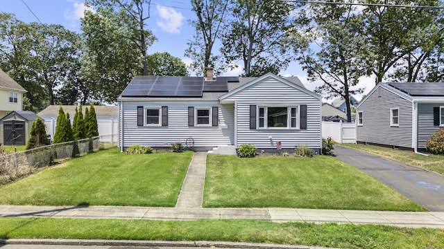107 May St, West Haven, CT 06516 - view of front of house with solar panels, a chimney, and roof with shingles