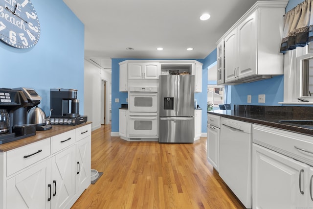 107 May St, West Haven, CT 06516 - kitchen with white appliances, light wood-style floors, white cabinets, and recessed lighting