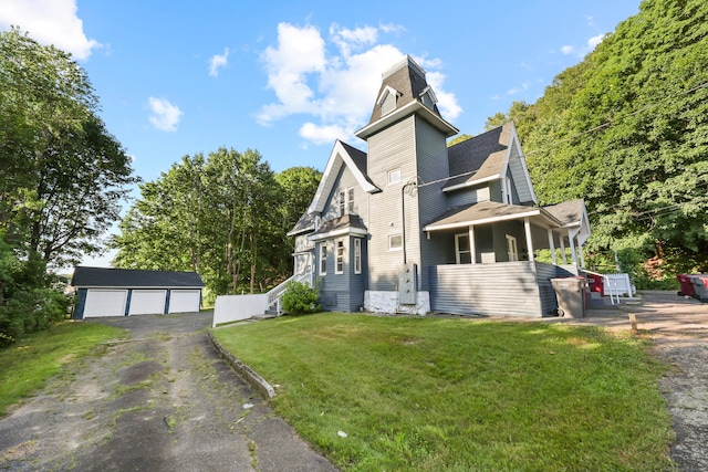 122 Oak St, Naugatuck, CT 06770 - view of front of property featuring a garage, a front yard, an outdoor structure, and roof with shingles