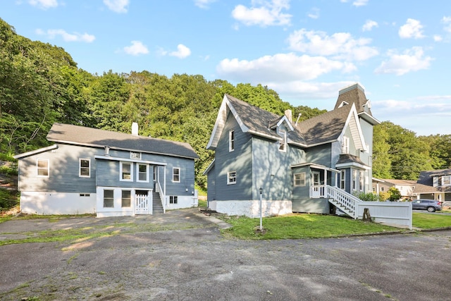 122 Oak St, Naugatuck, CT 06770 - view of front facade with a chimney and roof with shingles
