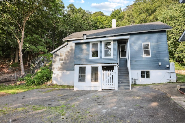 122 Oak St, Naugatuck, CT 06770 - rear view of house featuring a chimney