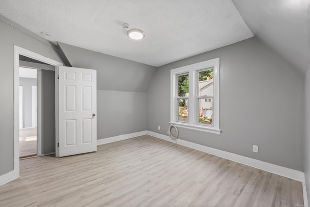 122 Oak St, Naugatuck, CT 06770 - bonus room featuring vaulted ceiling, light wood-style flooring, and a textured ceiling