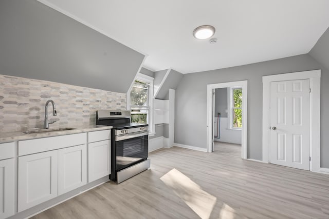 122 Oak St, Naugatuck, CT 06770 - kitchen featuring stainless steel electric range, vaulted ceiling, decorative backsplash, white cabinets, and light wood-style floors